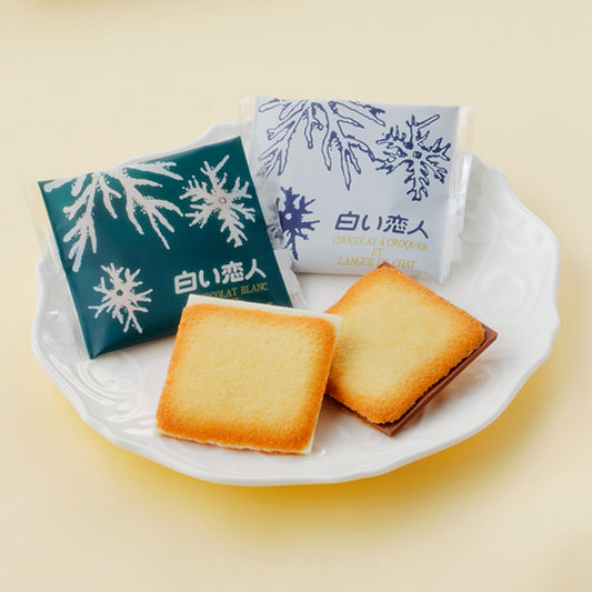 Shiroi Koibito is a popular Japanese confectionery consists of two thin butter cookies sandwiched together with a layer of white chocolate in between. The cookie part of the confection is made in the style of "langue de chat" cookies, creating a light and crispy texture. The white chocolate filling adds a sweet and creamy flavor to the overall taste. It has become a popular souvenir from Hokkaido, known for its quality dairy products and sweets.