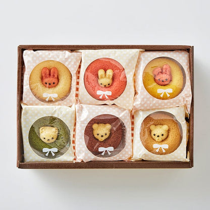 Box of 12 individually wrapped animal-shaped sponge cakes in assorted flavors including strawberry, plain, banana, chocolate, matcha, and caramel. Shaped like cute rabbits and bears, neatly arranged in a rectangular gift box measuring 21 × 30.2 × 8.5 cm.